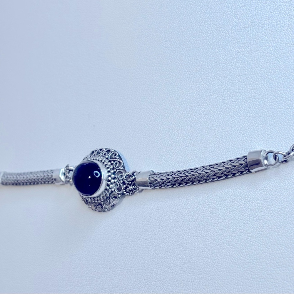 Elegant Sterling Silver Bracelet with Dark Purple Stone.